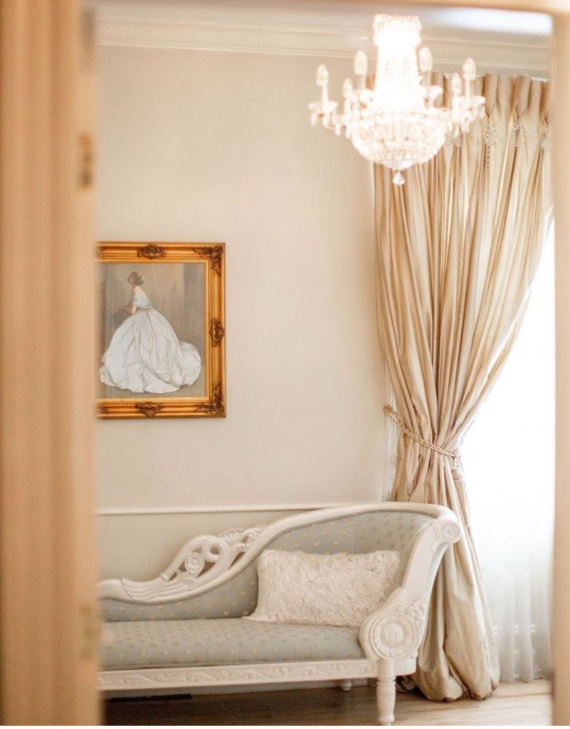 Bridal suite with chaise lounge and crystal chandelier at The Commons 1854