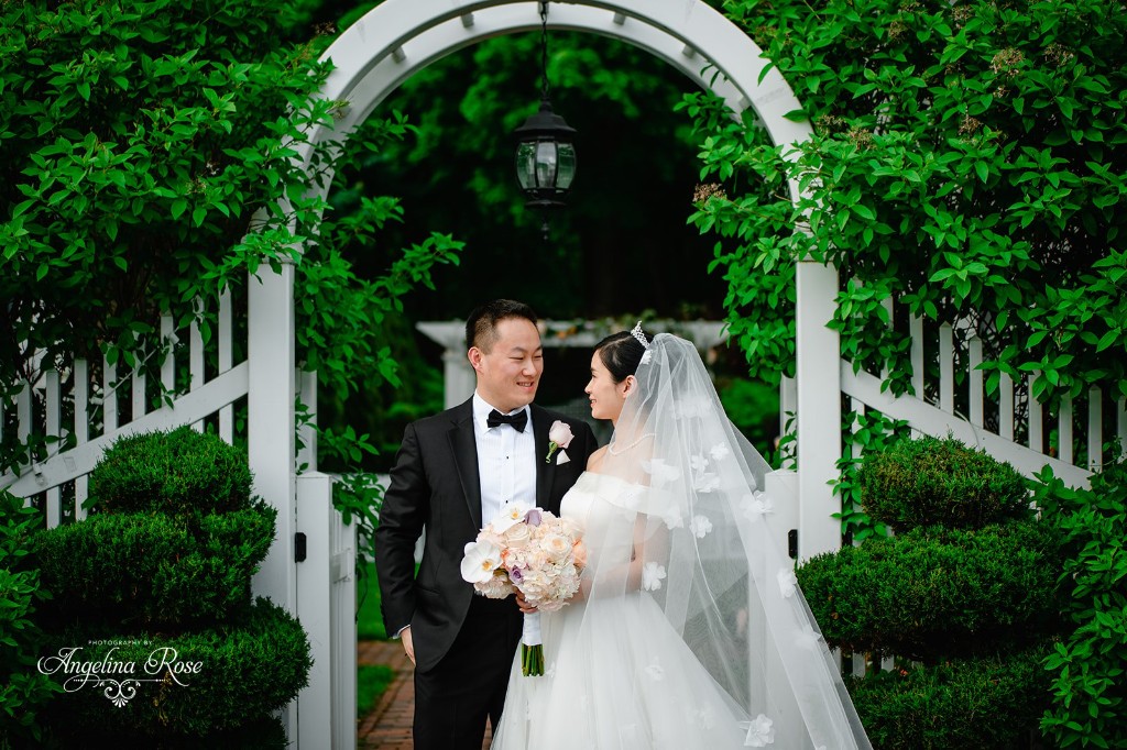 Couple at garden arch in summer at The Commons 1854 Topsfield