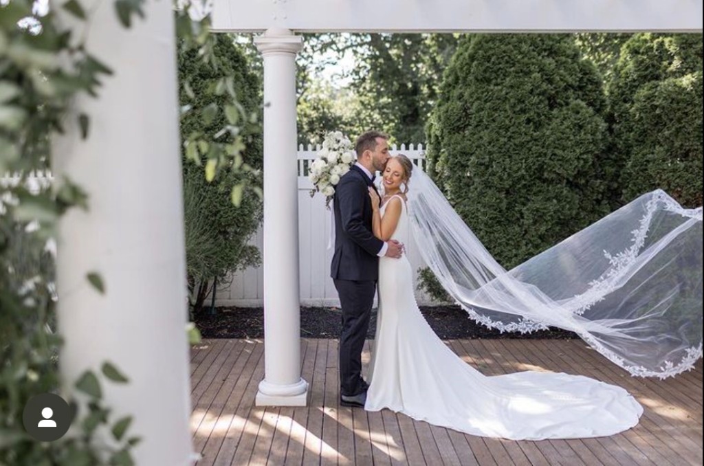 Couple at pergola with flowing veil at The Commons 1854