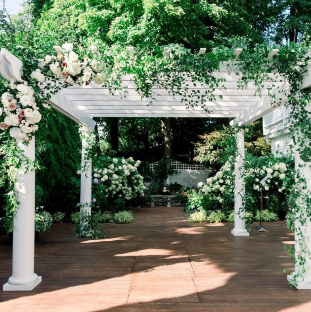 Pergola with summer greenery at The Commons 1854 garden