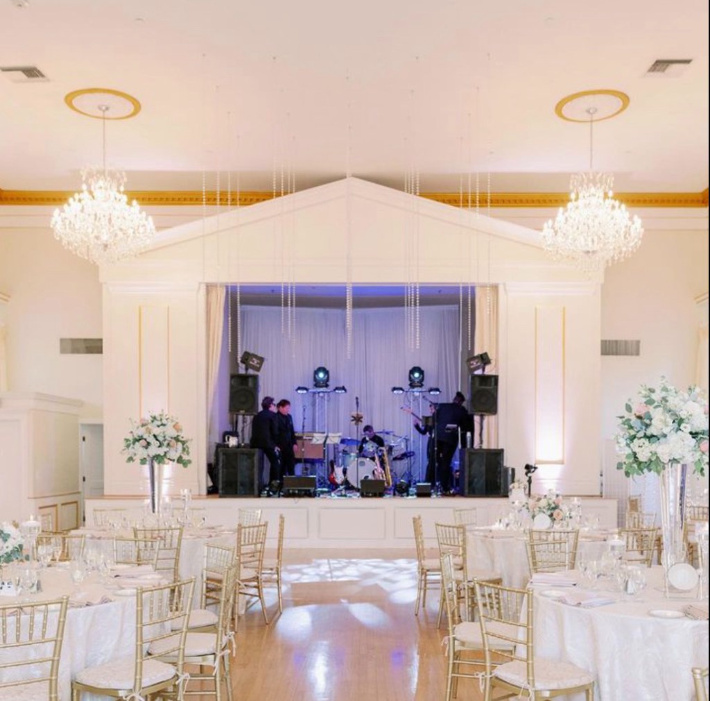 Live band on stage in the ballroom at The Commons 1854