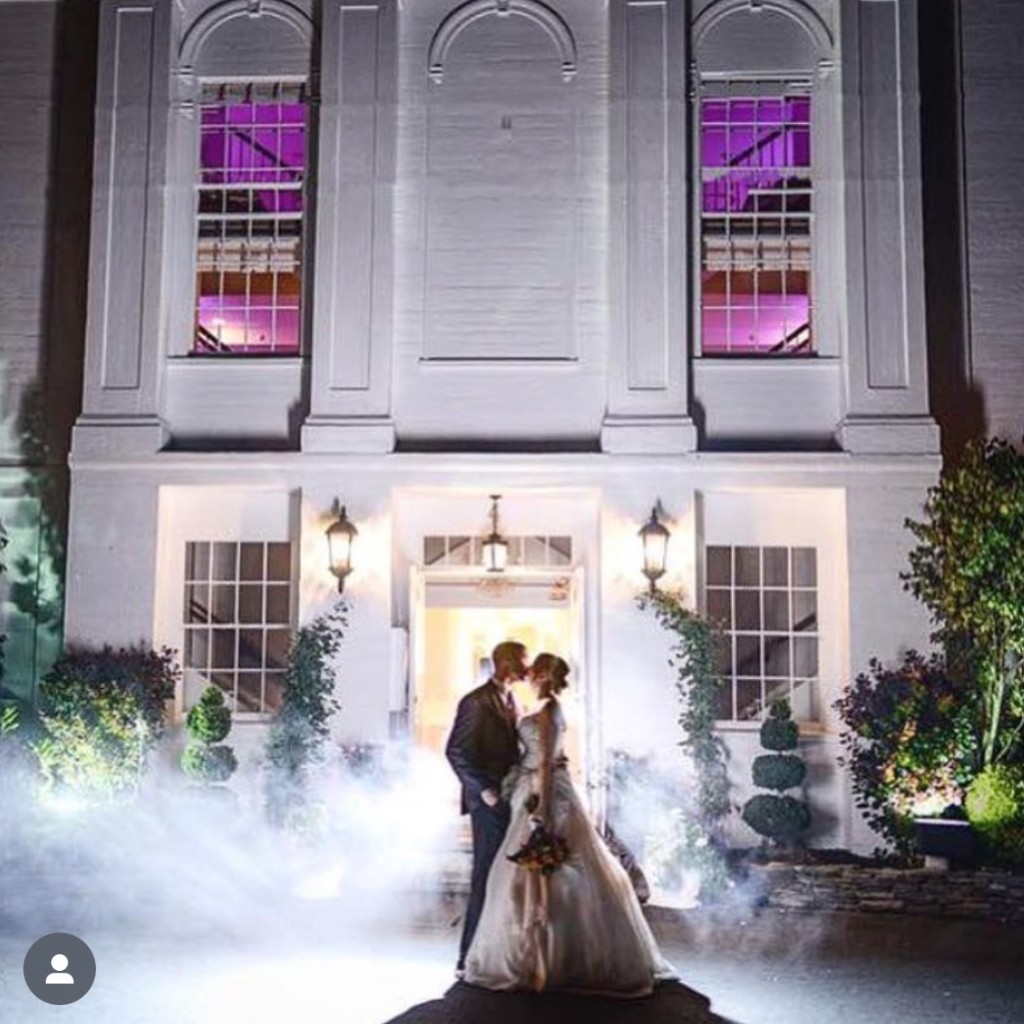 Couple kissing outside The Commons 1854 with fog and purple lights