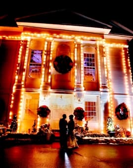The Commons 1854 building at night with lights